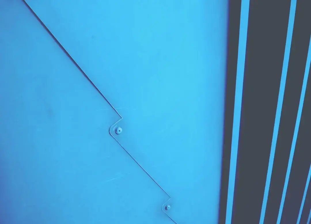 a blue wall with a hole in it