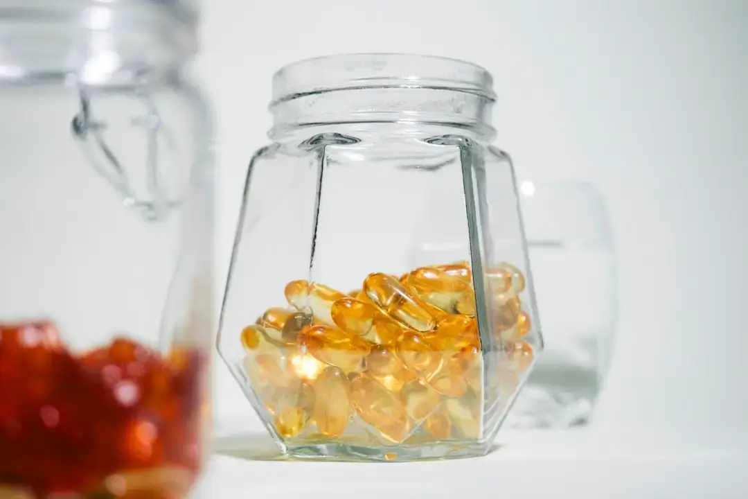 A glass jar filled with jelly beans next to another glass jar filled with jelly beans