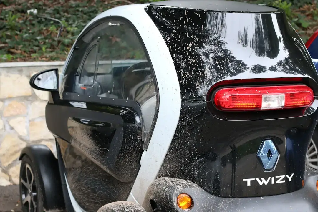 a smart car parked next to a stone wall