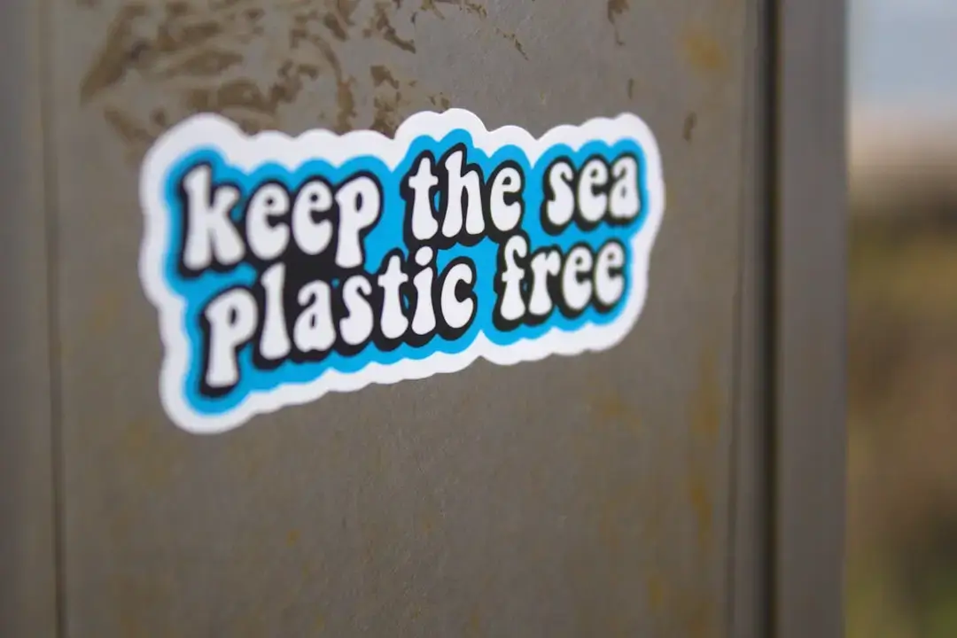 a sticker on the side of a trash can reads keep the sea plastic free