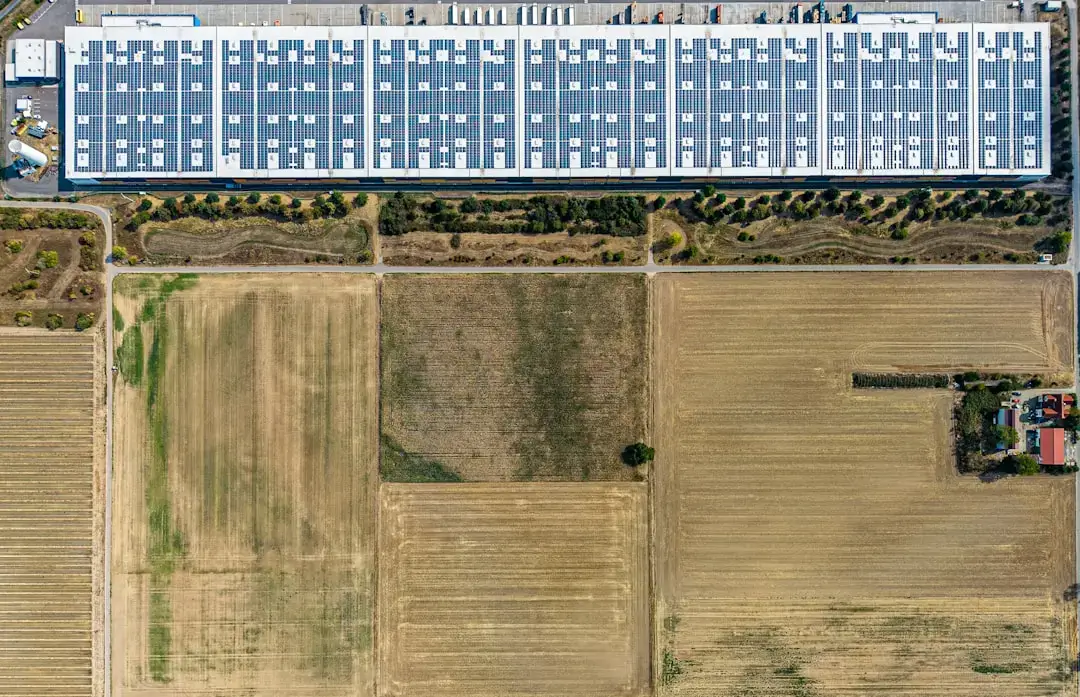 A bird's-eye view of a vast array of solar panels installed in a solar farm, representing renewable energy and sustainable technology.