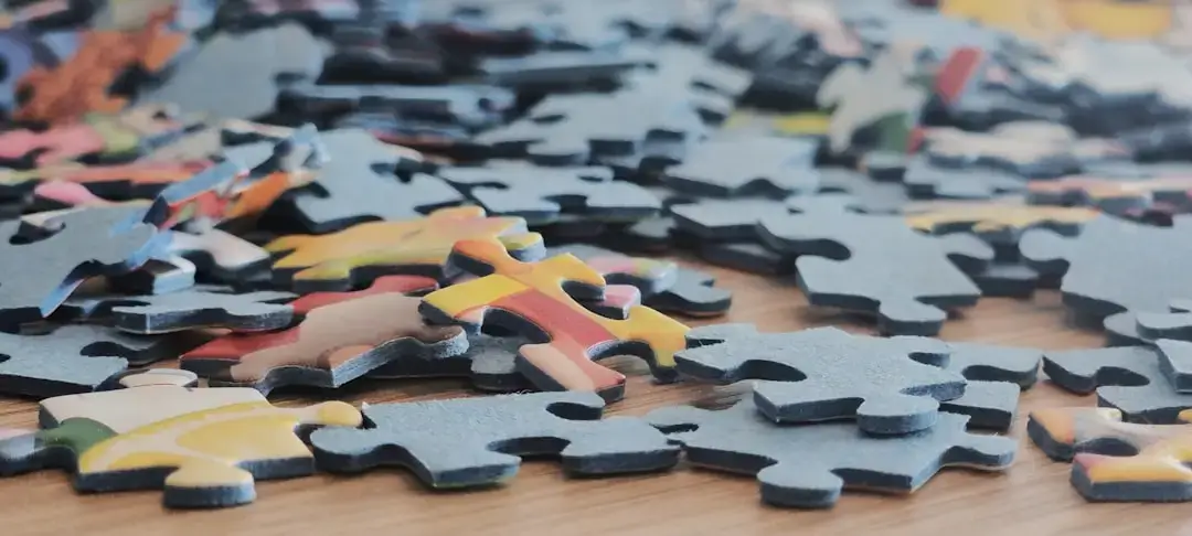 Colorful wooden alphabet puzzle pieces scattered on a flat surface for early childhood learning.