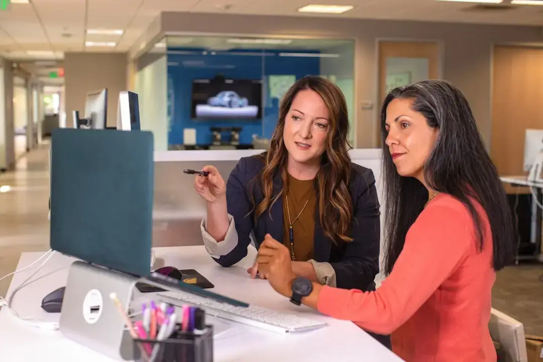A group of professional colleagues collaborating around a table during a strategic business meeting in a modern office.