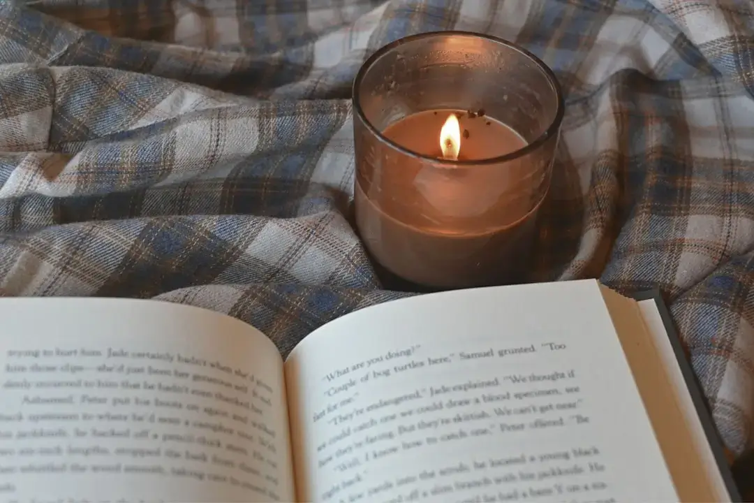 Several small burning tealight candles glowing with a warm, soft flame in a cozy setting