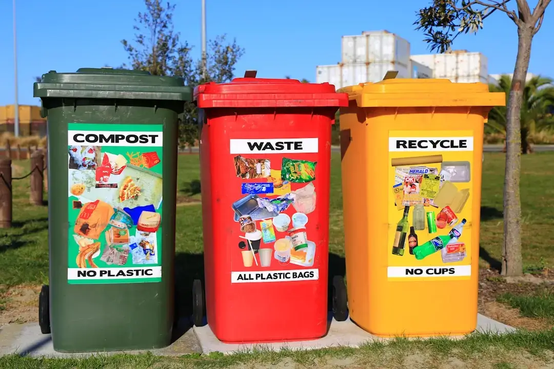 A close-up of color-coded recycling bins for sorting plastic, paper, and organic waste