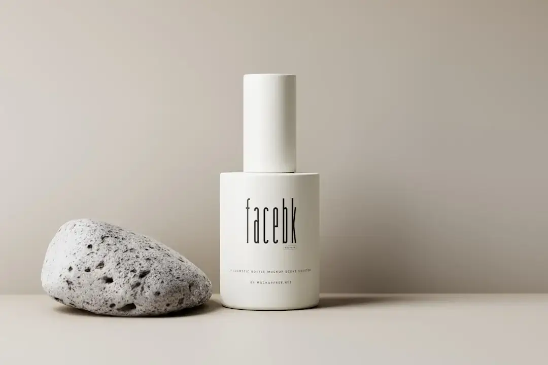 An assortment of high-end cosmetic bottles and skincare products arranged on a clean, minimalist surface.