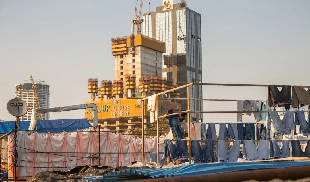 A large metal construction waste container filled with debris on a building site