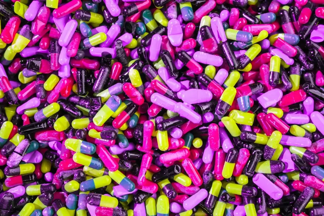 Close-up view of vibrant colorful raw plastic granules and chemical polymer pellets used in manufacturing