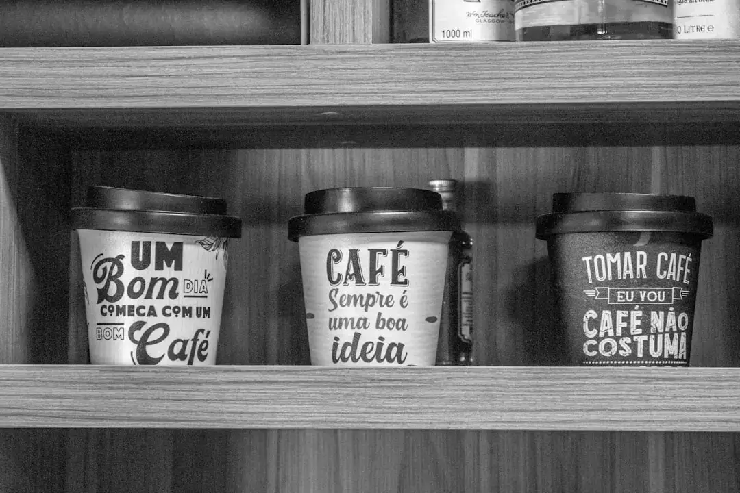 A person holding a modern reusable coffee cup in a sustainable lifestyle setting.