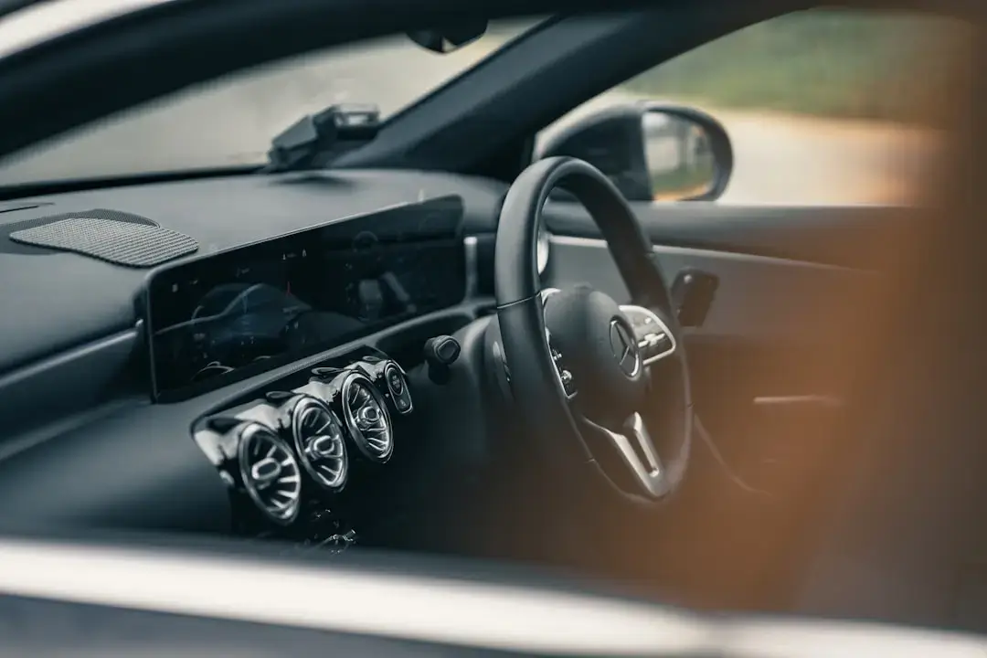 Close-up view of a modern electric car interior featuring a minimalist dashboard and large touchscreen display.