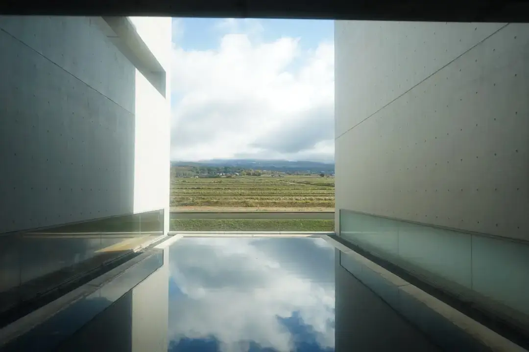 A modern sustainable residential building featuring an integrated rainwater harvesting system and green design elements.