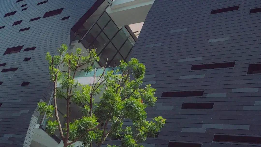 A modern sustainable urban landscape featuring eco-friendly buildings with vertical gardens and green public spaces.