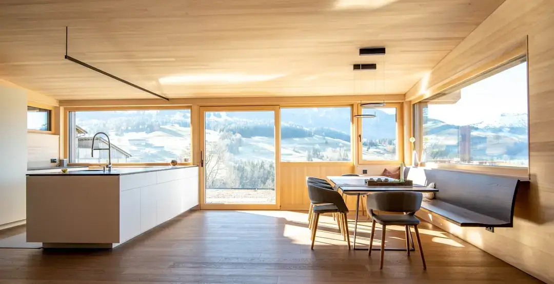 A contemporary eco-friendly house built with sustainable wood featuring large windows and natural materials integrated into the landscape.