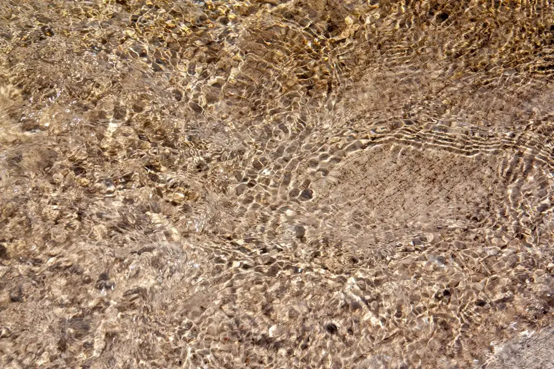 A close-up view of clear water flowing through a modern filtration system representing different purification stages.