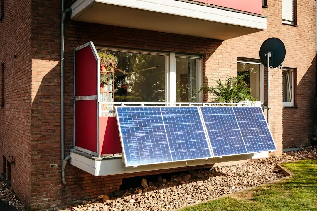 Close-up of a blue silicon photovoltaic cell showing the detailed grid structure for solar energy conversion.
