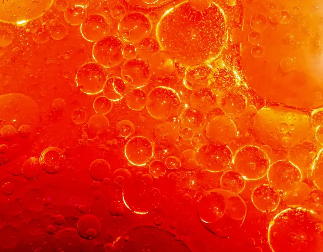 Close-up of carbonation bubbles rising in a refreshing glass of fizzy soda.