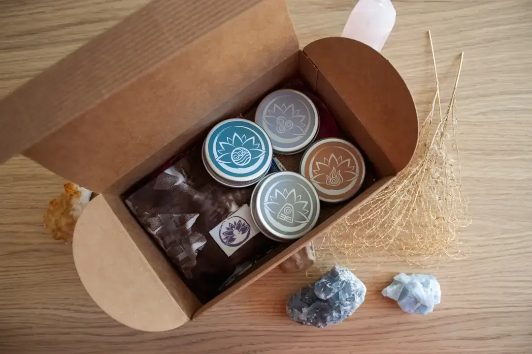 Selection of eco-friendly sustainable gift items wrapped in plastic-free brown paper with tied twine and green leaves.