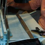 a man is working on a weaving machine