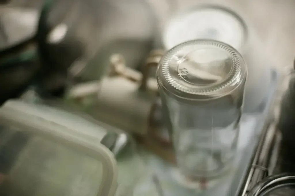 Close-up of an empty glass bottle on a shelf.