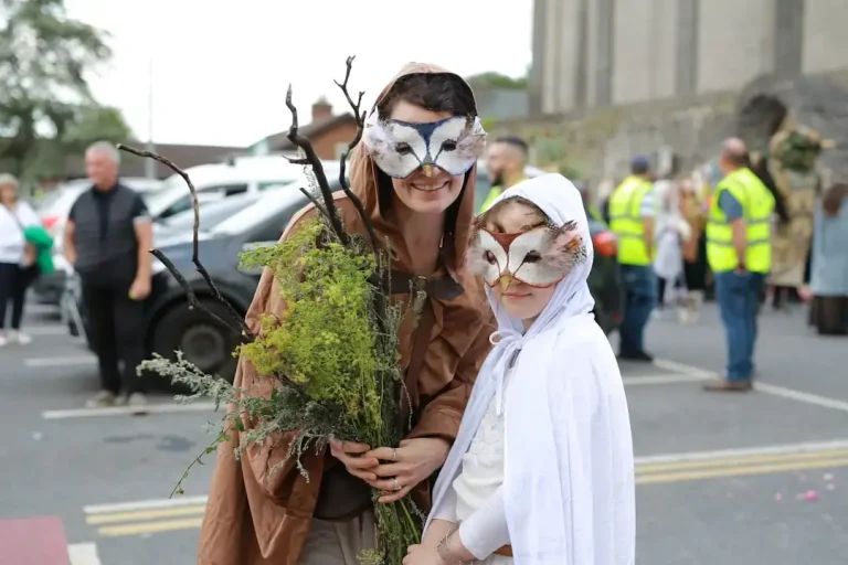 Two people in owl masks and costumes