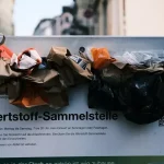 a bunch of bags sitting on top of a sign