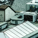 white wooden bench beside gray brick wall