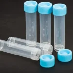 a group of four plastic bottles sitting on top of a table