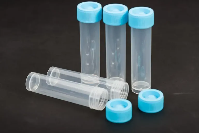 a group of four plastic bottles sitting on top of a table