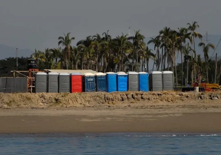 A row of beach huts sitting on top of a sandy beach