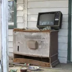 black crt tv on brown wooden table