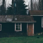 an old run down house with a rusty roof