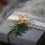 a present wrapped in gray paper with a brown ribbon