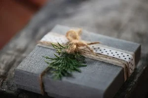 a present wrapped in gray paper with a brown ribbon