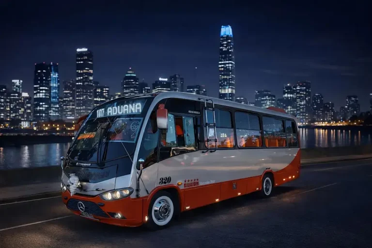 Bus driving on a road at night with city lights.