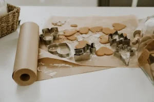 Colorful cotton fabric patterns being coated with melted beeswax to create reusable eco-friendly food wraps