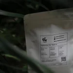A close-up of a green ecological label on a sustainable product box representing environmental certification.