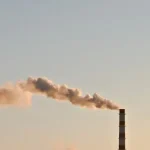 A conceptual image showing the environmental impact of industrial inventions on nature and pollution.