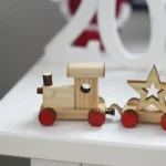 A variety of sustainable and ecological wooden toys and gifts for children arranged on a natural background.