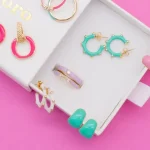 Close-up of elegant jewelry pieces made from recycled materials on a neutral background