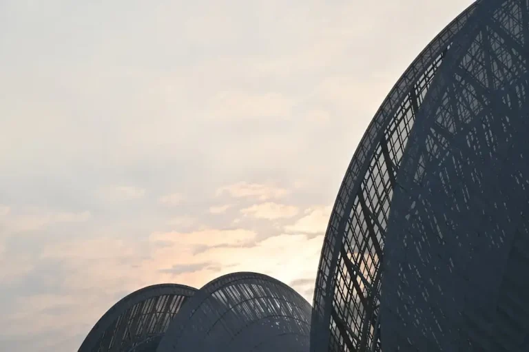 A large parabolic mirror reflecting sunlight to generate concentrated thermal energy for heating.