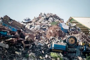 Close-up of organized metallic car components at a recycling facility for proper disposal.