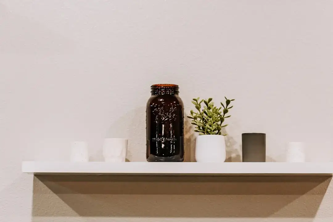 A collection of glass jars and reusable items representing a sustainable zero waste lifestyle on a wooden surface.